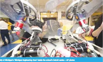  ??  ?? DETROIT: Students work on their team’s robot inside the University of Michigan’s ‘Michigan Engineerin­g Zone’ inside the school’s Detroit center.—AP photos