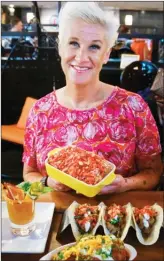  ?? The Associated Press ?? Food Network star Anne Burrell shows off some of her creations for an all-Cheetos menu for a three-day pop-up restaurant in New York. Menu includes, Cheetos meatballs, Cheetos crusted fried pickles, Cheetos tacos, Mac n' Cheetos and Cheetos cheesecake.