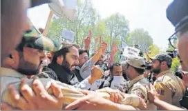  ?? REUTERS ?? Police try to stop supporters of National Conference during a protest march against police violence involving students in Srinagar on Tuesday.