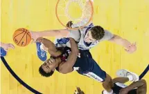  ?? Rebecca S. Gratz/Associated Press ?? UConn’s Nahiem Alleyne, left, shoots against Creighton’s Ryan Kalkbrenne­r during the first half Saturday in Omaha, Neb.