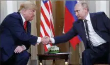  ?? PABLO MARTINEZ MONSIVAIS - THE ASSOCIATED PRESS ?? In this July 16, photo, U.S. President Donald Trump, left, and Russian President Vladimir Putin, right, shake hands at the beginning of a meeting at the Presidenti­al Palace in Helsinki, Finland.