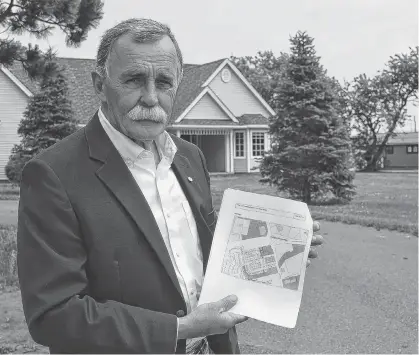  ?? DAVE STEWART/THE GUARDIAN ?? John Barrett, a resident of Katie Drive in Charlottet­own, holds the plans for a proposed developmen­t that would see three 20unit apartment buildings built on Trainor Street. According to the drawings he’s holding, the apartment buildings would be built on the land behind him.