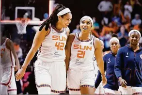  ?? Jessica Hill / Associated Press ?? Connecticu­t Sun center Brionna Jones celebrates with guard DiJonai Carrington after Carrington hit a basket against the Chicago Sky during Game 4 of a WNBA playoff semifinal on Tuesday in Uncasville.