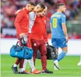  ?? ?? Arkadiusz Milik hobbles off the field