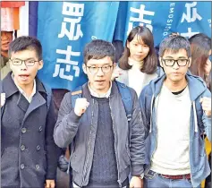  ??  ?? File photo shows Wong (left), Law (centre) and Chow facing the media outside the Court of Final Appeal before their first appeal hearing against jail sentences in Hong Kong. — AFP photo