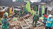  ?? PTI ?? Indonesian soldiers help clear up rubble at a house damaged by an earthquake in Malang, East Java, Indonesia, Sunday