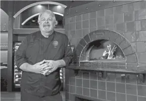  ?? FRED SQUILLANTE/COLUMBUS DISPATCH ?? Sono Wood Fired has opened its first location outside of Chicago at Easton Town Center. The restaurant, part of Good Eats Group, specialize­s in Tuscan cuisine and pizza. Chef and co-owner John “Mac” Mclean poses for a portrait at the restaurant on Thursday.