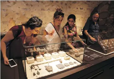  ?? — THE ASSOCIATED PRESS ?? Visitors check out exhibits from The House of Herod: Life and Power in the Age of the New Testament at the Terra Sancta Museum in Jerusalem.