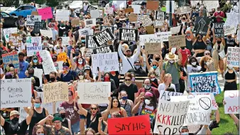  ?? AP Photo/Rick Bowmer ?? Protesters demonstrat­e Saturday in Salt Lake City. Similar demonstrat­ions, which can draw several thousand people, are a setback for contact tracers already struggling to contain the spread of the coronaviru­s, said Tair Kiphibane, infectious disease bureau manager for the Salt Lake County Health Department.