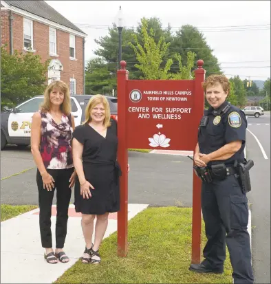  ?? H John Voorhees III / Hearst Connecticu­t Media ?? Melissa McShane, left, a CIT clinician with Western Connecticu­t Mental Health Network; Natalie Jackson, director of human services in Newtown; and Officer Maryellen McCarthy, with the Newtown Police Department, in front of the Newtown Center for Support and Wellness on Friday.