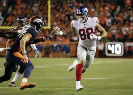  ?? AP PHOTO/JACK DEMPSEY ?? Giants tight end Evan Engram runs upfield after making catch against Broncos last season in Denver.