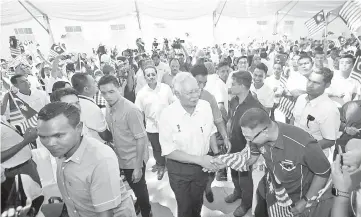  ??  ?? Datuk Seri Najib Razak shakes hands with people at an event with the staff of DRB-Hicom in Pekan yesterday. — Bernama photo