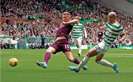  ?? Picture: Andrew Milligan/PA ?? Hearts defender Taylor Moore tries to block a shot from Celtic’s Daizen Maeda during the Scottish Premiershi­p game at Celtic Park last Saturday