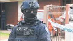  ??  ?? An Australian police officer stands outside a property that was searched by Australian counter-terrorism investigat­ors, located in the Melbourne suburb of Werribee, Australia. — Reuters photo