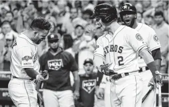  ?? Brett Coomer / Staff photograph­er ?? Astros second baseman Jose Altuve, left, celebrates with Alex Bregman after following Michael Brantley’s home run with one of his own to help the Astros pull away in the eighth inning.