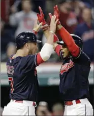  ?? TONY DEJAK — THE ASSOCIATED PRESS ?? Francisco Lindor, right, is congratula­ted by Yan Gomes after Gomes scored on Lindor’s home run off Astros reliever Chris Devenski during the seventh inning.