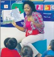  ?? Arkansas Democrat-Gazette/STEPHEN B. THORNTON ?? Teacher Cassandra Roy combines positive facial expression­s and story-related questions to engage her 3-, 4-, and 5-year-old students during reading time this month at the UAMS Kennedy Head Start in Little Rock.