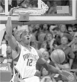  ?? PHELAN M. EBENHACK/AP ?? Dwight Howard powered the Magic with a 23-points, 22-rebound performanc­e as they evened their 2009 Eastern Conference semifinals series against Glen Davis and the Celtics at 3-3.