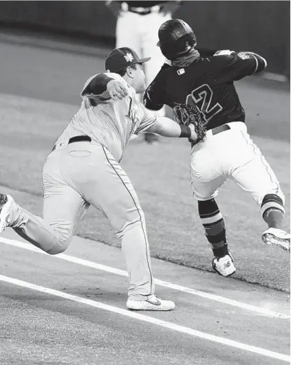  ?? WILFREDO LEE/AP ?? Rays first baseman Ji-Man Choi, left, tags out the Marlins’ Jon Berti along the first-base line during Saturday’s game in Miami.