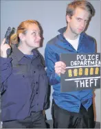  ??  ?? Officer Krista (Krista Church) is putting the pressure on David Tuttle (Johnathan Lewis) to come clean about his crimes as he poses for a mug shot in the side splitting Christmas comedy, Sorry! Wrong Chimney! by Jack Sharkey and Leo W. Sears. This Mira Players dinner theatre production will hit the stage December 1 and 2 at the Marion Bridge Community Hall. There will be a general performanc­e, Wednesday, November 29. Visit the Mira Players Facebook page for ticket informatio­n.