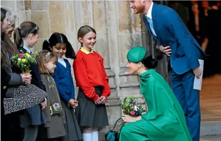  ?? AP ?? Harry and Meghan the Duke and Duchess of Sussex speak to children as they leave after attending the annual Commonweal­th Day service.