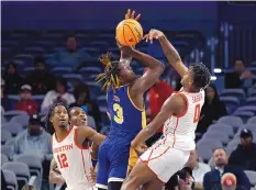  ?? RON JENKINS/ASSOCIATED PRESS ?? Houston’s Marcus Sasser (0) blocks a shot by East Carolina’s RJ Felton (3) during their game Friday in Fort Worth, Texas.