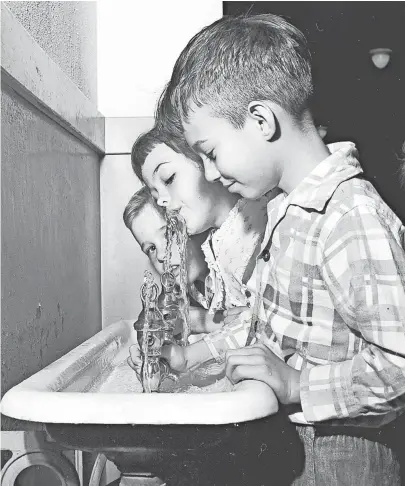  ??  ?? Flouride in water is tasteless and odorless, as these second grade youngsters at Germantown School find out on 10 April 1952. The children are Danny Detwiller (Right), Bebe Burford (center) and Jackie Wilcox. City manager C.C. Burford (not pictured)...