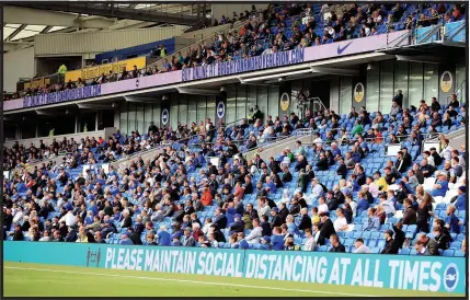  ??  ?? KEEP YOUR DISTANCE: Is this restricted crowd at Brighton any riskier than supporters gathering in a pub?