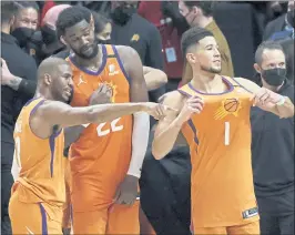  ?? HARRY HOW — GETTY IMAGES ?? From left, Chris Paul, Deandre Ayton and Devin Booker lead the Phoenix Suns into the NBA Finals against the Milwaukee Bucks. Game 1 is today in Phoenix.