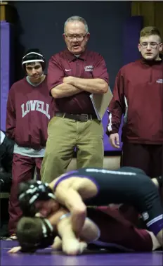  ?? JULIA MALAKIE — LOWELL SUN ?? During a quad meet at Shawsheen Tech on Dec. 23, 2015, Lowell High wrestling coach George Bossi looks on during a 106-pound match.