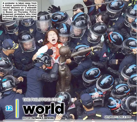  ?? EPA ?? A protester is taken away from a statue symbolizin­g Korea’s forced laborers on a sidewalk near the Japanese consulate in Busan on Thursday. Police dispersed protesters who tried to prevent the statue from being removed.