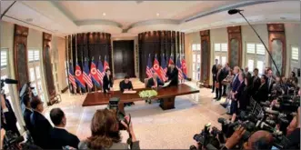  ?? KCNA VIA REUTERS ?? US President Donald Trump and the Democratic People’s Republic of Korea’s top leader Kim Jong-un sign documents in Singapore in this photo released on Tuesday by the DPRK’s Korean Central News Agency.