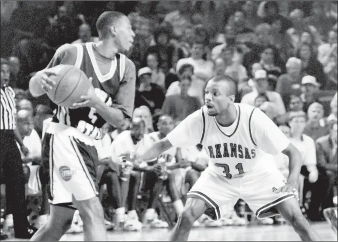  ?? File Photo ?? The Razorbacks’ Roger Crawford defends a Murray State player Nov. 29, 1993, in the first game played in Bud Walton Arena.