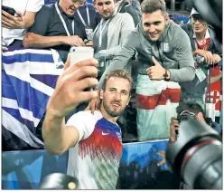  ?? Getty Images ?? MAN OF THE PEOPLE: Harry Kane poses for photos with England fans after defeating Colombia to advance to Saturday’s quarterfin­al match against Sweden.