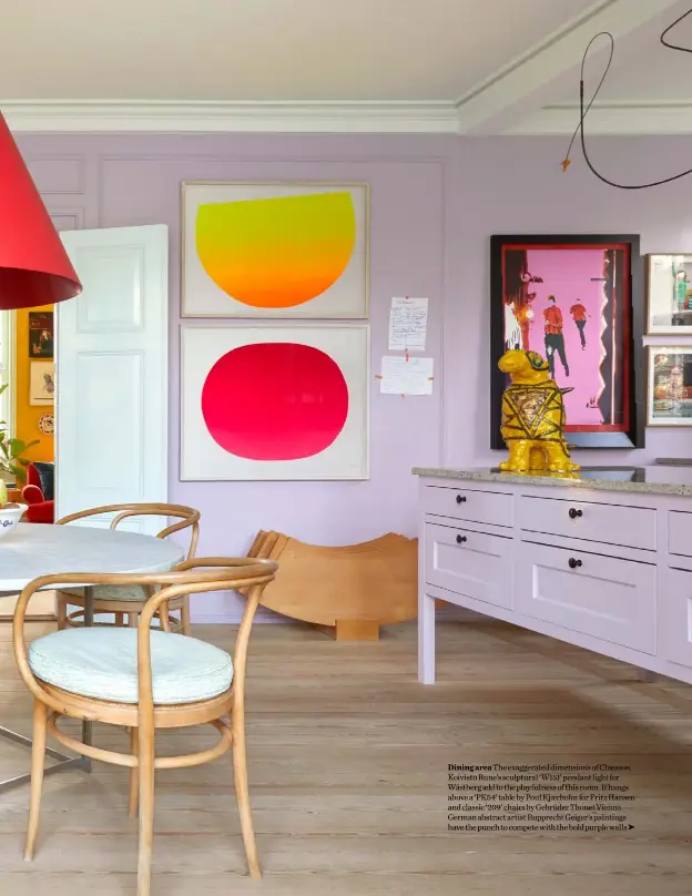  ??  ?? Dining area The exaggerate­d dimensions of Claesson Koivisto Rune’s sculptural ‘W151’ pendant light for Wästberg add to the playfulnes­s of this room. It hangs above a ‘PK54’ table by Poul Kjærholm for Fritz Hansen and classic ‘209’ chairs by Gebrüder Thonet Vienna. German abstract artist Rupprecht Geiger’s paintings have the punch to compete with the bold purple walls