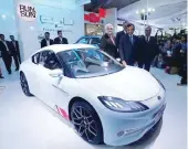  ?? — Reuters ?? Pawan Goenka, president of Mahindra’s automotive and farm equipment sectors, stands next to Mahindra’s concept electric sports car ‘Halo’ after its unveiling during the Indian Auto Expo in Greater Noida.