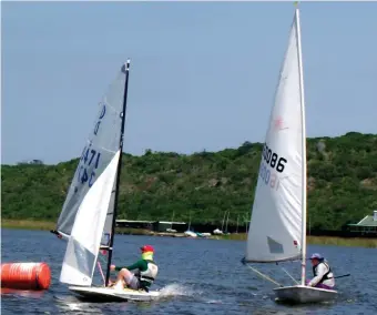  ?? Photos: Charles Norman ?? Matthew de Villiers on a Dabchick, rounding the first mark ahead of the Laser of Evelyn Osborne during Sunday’s racing at the George Lakes Yacht Club.