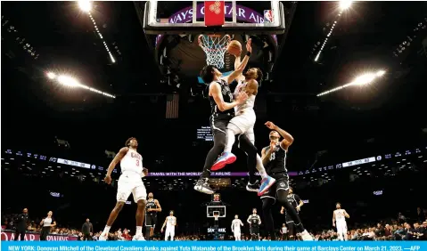  ?? ?? NEW YORK: Donovan Mitchell of the Cleveland Cavaliers dunks against Yuta Watanabe of the Brooklyn Nets during their game at Barclays Center on March 21, 2023. —AFP