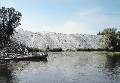  ?? DAVID BEBEE WATERLOO REGION RECORD ?? Huge piles of waste stone left from the Dolime Quarry back right up to the edge of the Speed River in the Guelph area.