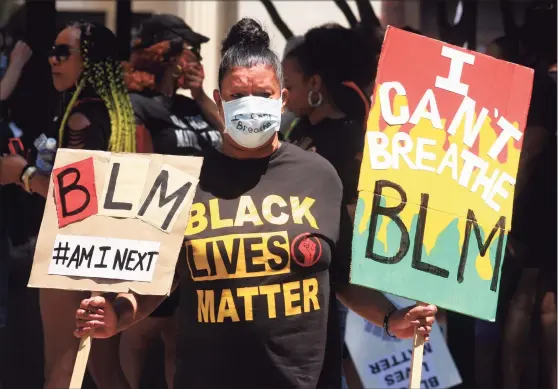  ?? Christian Abraham / Hearst Connecticu­t Media file photo ?? In the aftermath of George Floyd’s murder, Betsy Cuevas, of Bridgeport, joins more than 100 Black Lives Matter protesters for a march from McLevy Green to a rally at nearby Seaside Park in downtown Bridgeport on June 20, 2020.