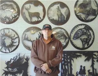  ??  ?? Mike Beaudoin with some of his metal art creations.