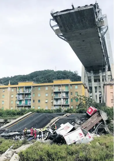  ?? VIGILI DEL FUOCO VIA THE ASSOCIATED PRESS ?? Italian firefighte­rs work amid the rubble of the collapsed highway bridge in Genoa, northern Italy, on Tuesday.