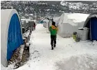  ?? AP ?? Displaced Syrians endure the cold at a camp near the Turkish border in Idlib province.