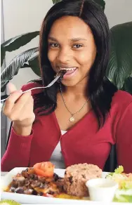  ??  ?? Monique Jackson takes a bite of tasty stewed beef.