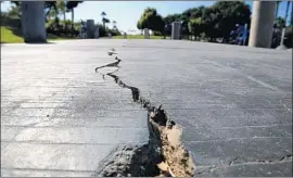  ?? Allen J. Schaben Los Angeles Times ?? A LONG CRACK splits the sidewalk at Discovery Well Park in Huntington Beach. The park, named for an oil strike, is atop the Newport-Inglewood fault.