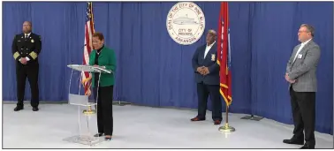  ?? (Arkansas Democrat-Gazette/Dale Ellis) ?? Pine Bluff Fire Chief Shauwn Howell (from left), Mayor Shirley Washington, Police Chief Kelvin Sergeant, and Jefferson Regional Medical Center CEO Brian Thomas stand in a wide semicircle during a news conference Tuesday at the Pine Bluff Convention Center to provide updates on the covid-19 pandemic. Attendance was limited to city officials and media representa­tives. The news conference was live-streamed on the city’s Facebook page.