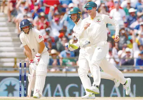  ?? — Reuters ?? Australia’s captain Steve Smith celebrates with team-mates after taking a catch to dismiss England’s captain Joe Root during the fourth day of the third Test.