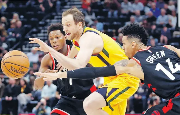  ?? RICK BOWMER / THE ASSOCIATED PRESS ?? Utah Jazz forward Joe Ingles drives to the basket as Toronto Raptors Kyle Lowry and Danny Green defend in Monday night’s game in Salt Lake City. For a full report on the game and more on the NBA, go to national post.com.