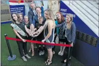  ?? Katharine Lotze/The Signal ?? Jacinda Molina, left, and Madison Hollers, right, help the family of Ventura County firefighte­r Ryan Osler, former Saugus principal Bill Bolde, center, and current Saugus principal Vince Ferry, back, cut the ribbon to commemorat­e the First Responders...