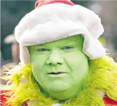  ?? Picture: AFP ?? A runner dressed in a Grinch-Santa Claus outfit participat­es in the Race of the Santas in Breckenrid­ge, Colorado.